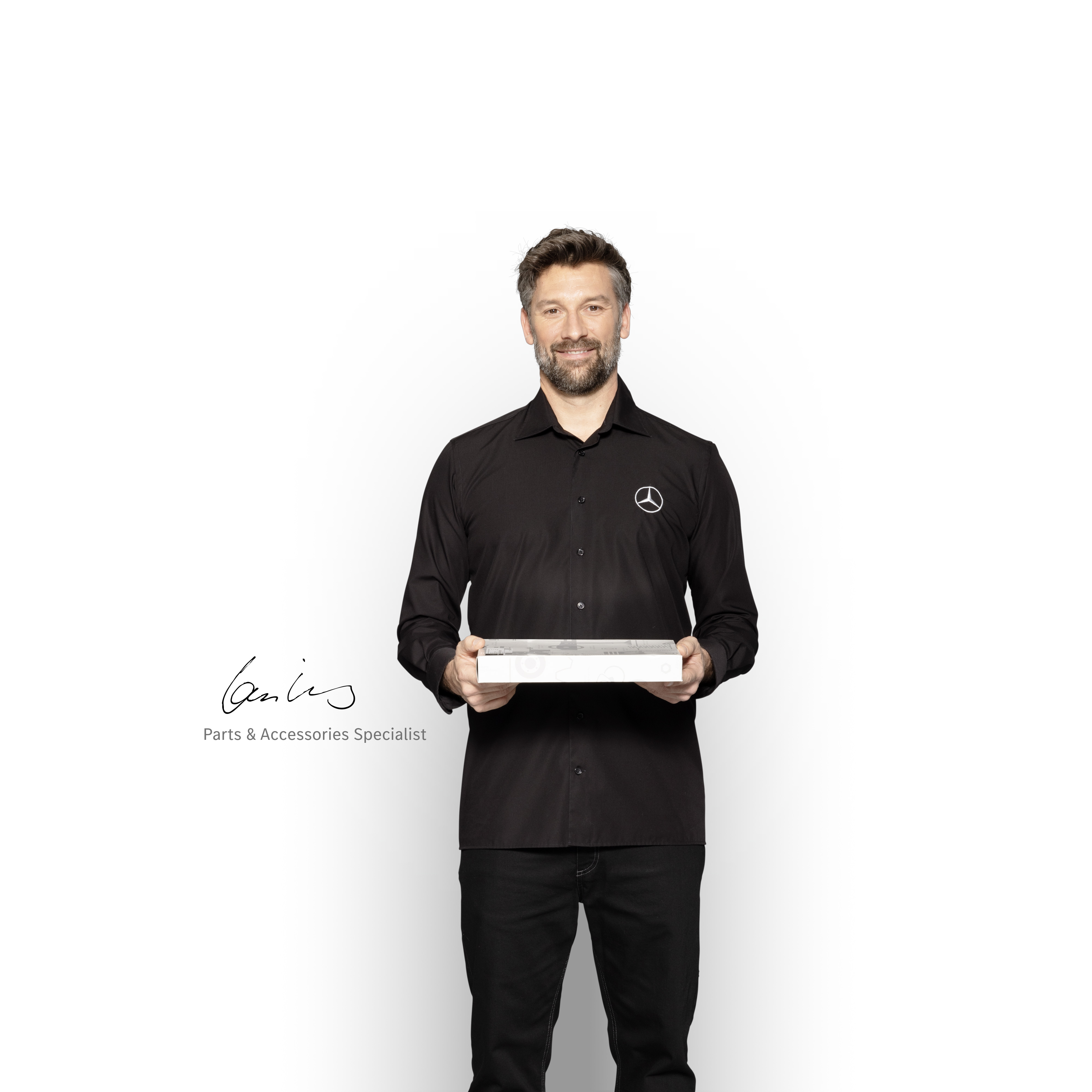 Mercedes-Benz | Transporter Qualität Original-Teile Mercedes-Benz Techniker mit einer Box in der Hand, um Mercedes-Benz Original-Teile zu zeigen.