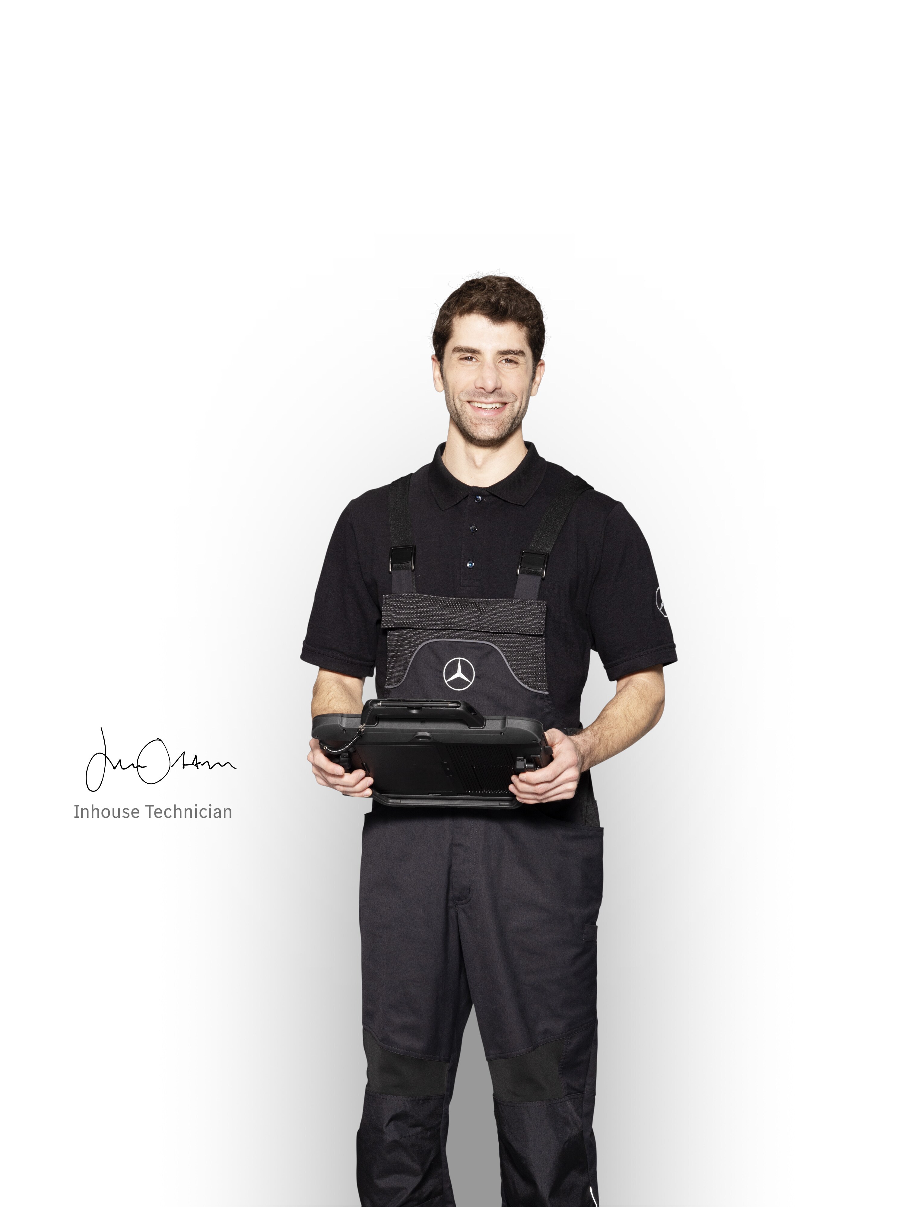 Mercedes-Benz Mechaniker in Arbeitskleidung hält ein Tablet für die Schadensmeldung bereit.