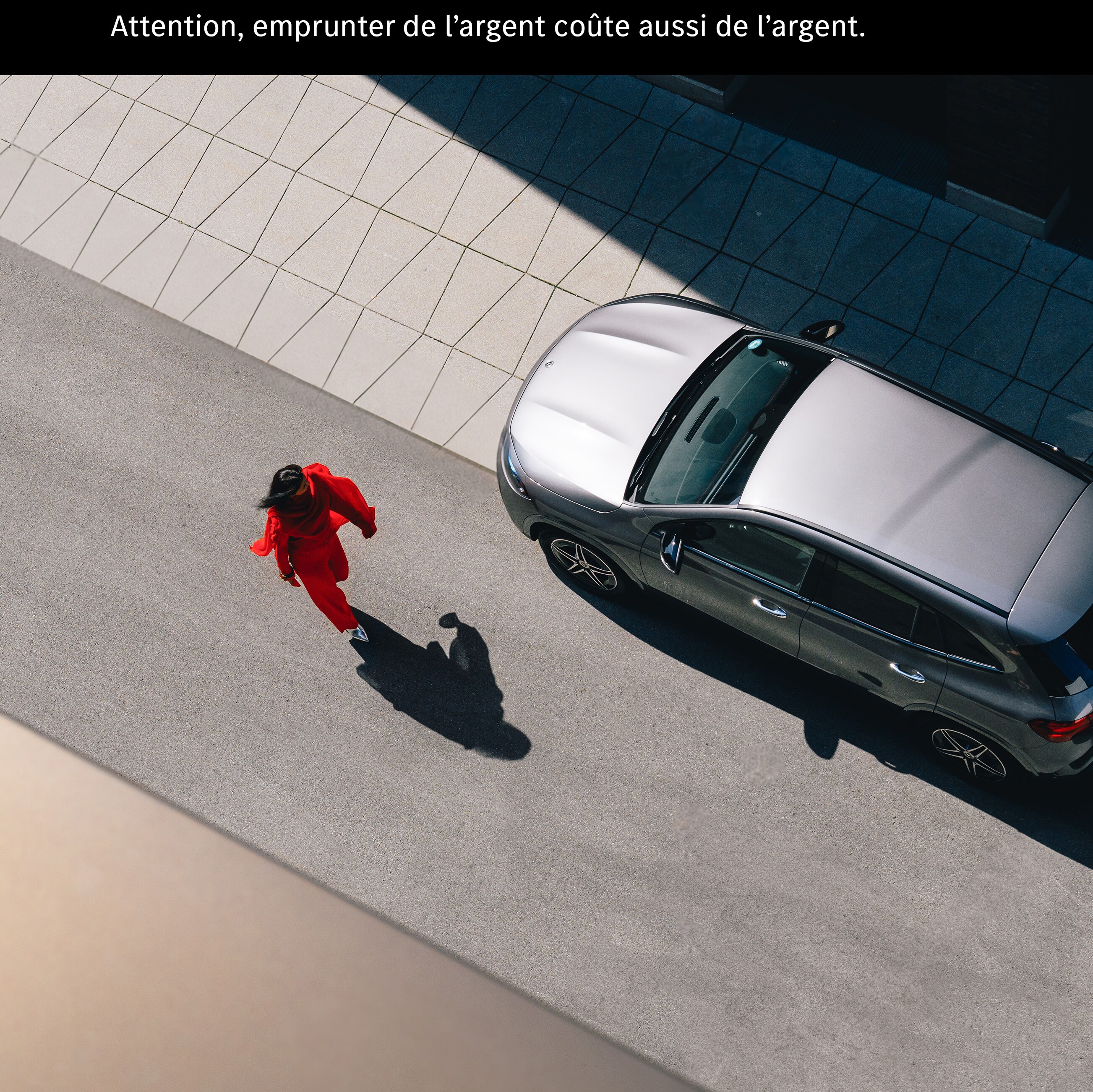 Une femme s’approche d’une Mercedes EQA.