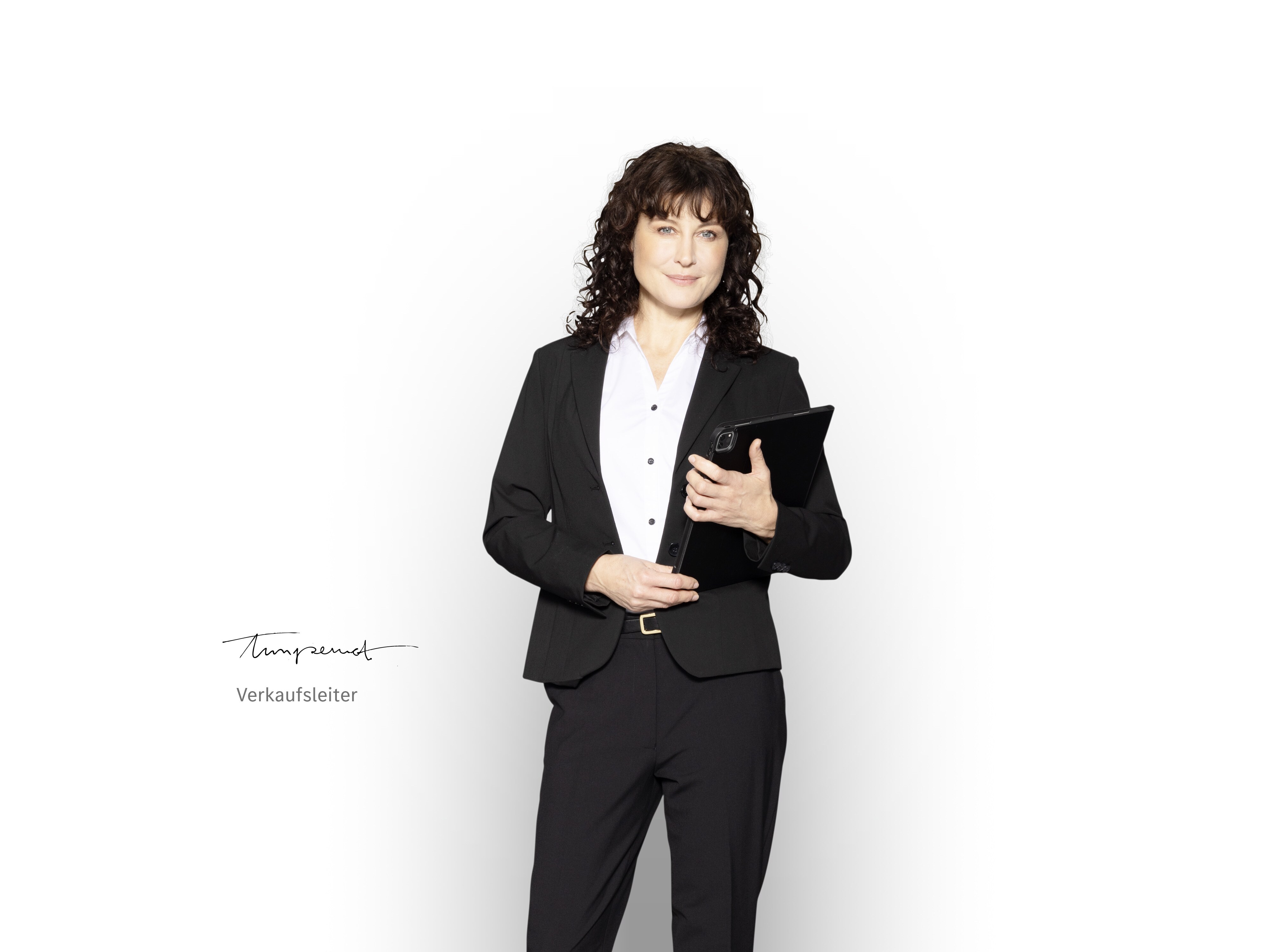 Mercedes-Benz Verkaufsleiter mit Tablet in der Hand, um über die Neufahrzeuggarantie zu informieren.