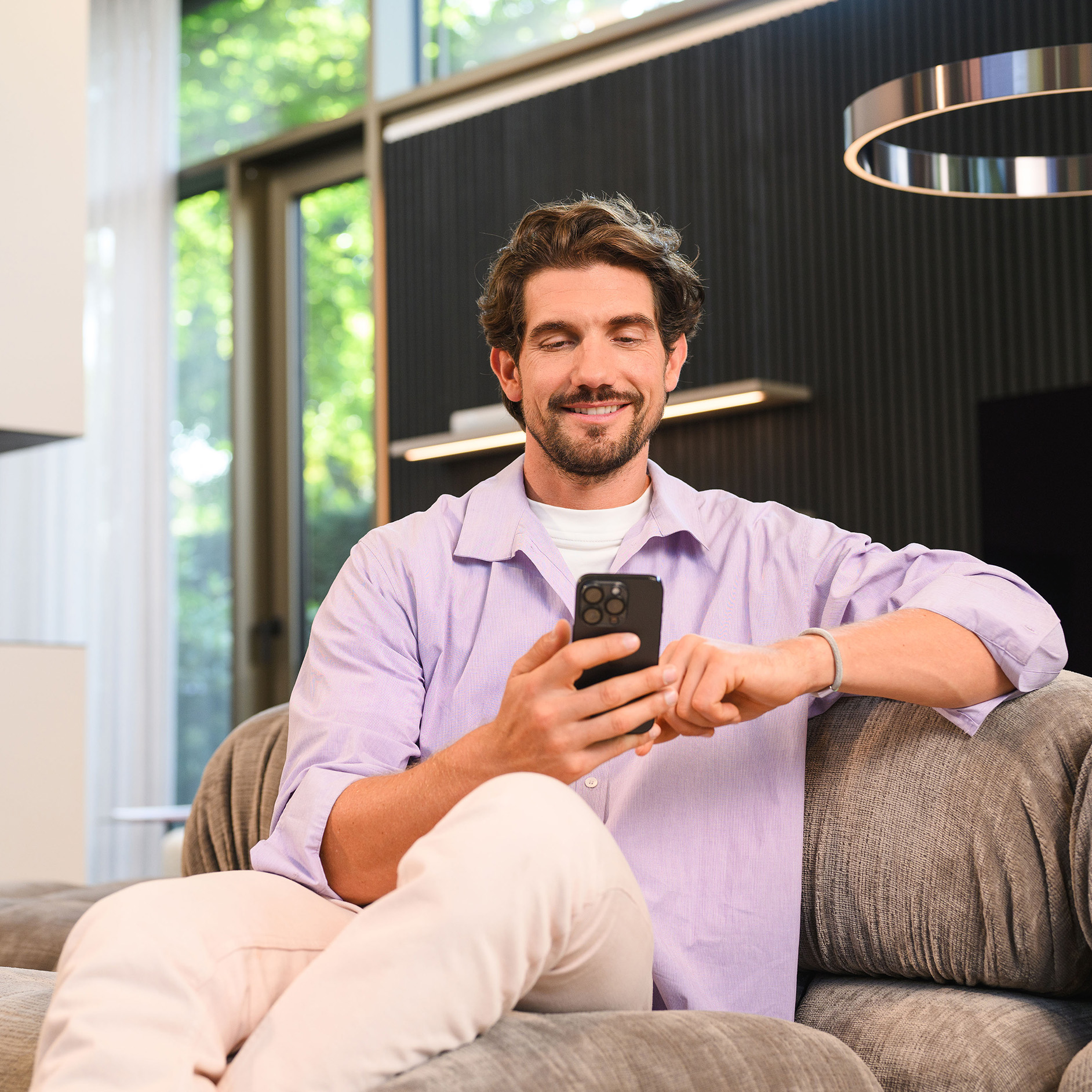 Homme consultant des informations sur son smartphone. Homme consultant le site web Mercedes-Benz sur son smartphone.